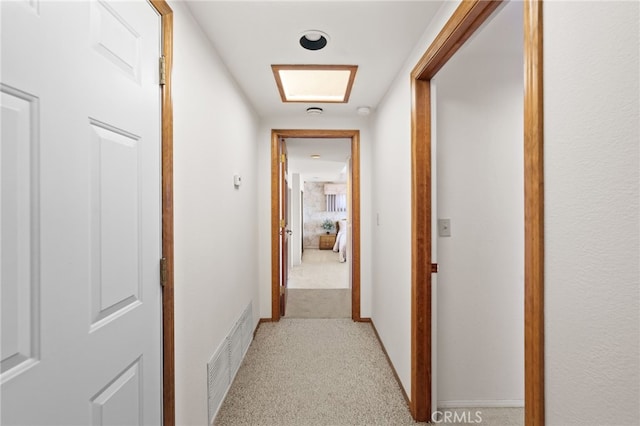 corridor with light colored carpet