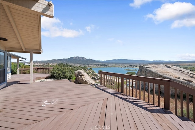 deck with a water and mountain view