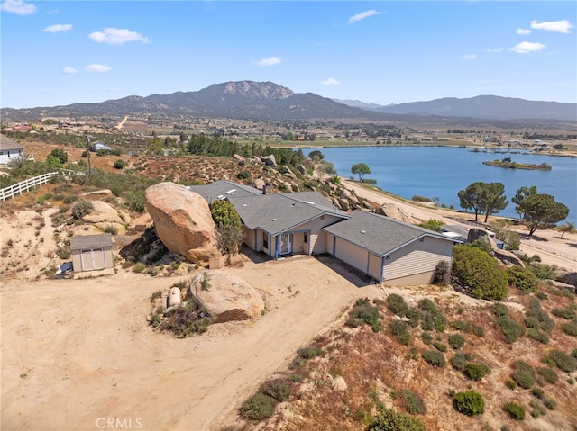 drone / aerial view featuring a water and mountain view