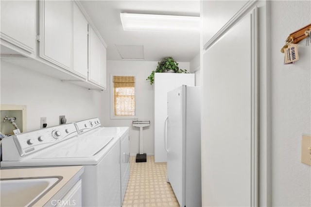 washroom featuring cabinets and independent washer and dryer