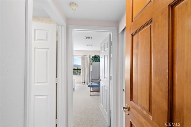 hallway with light colored carpet