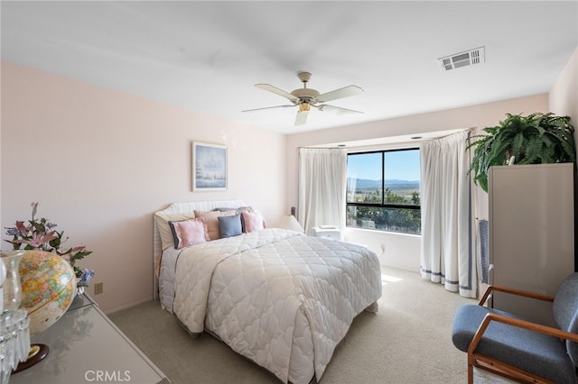 bedroom with light carpet and ceiling fan