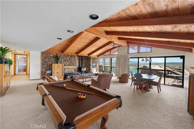 playroom with lofted ceiling with beams, light carpet, a wood stove, a water view, and pool table