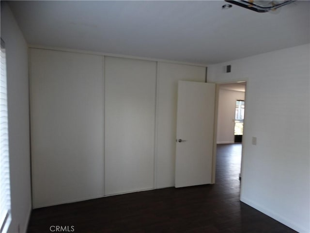 spare room featuring dark wood-type flooring