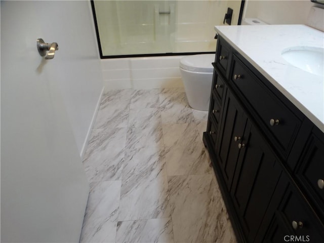 full bathroom featuring vanity, toilet, and enclosed tub / shower combo