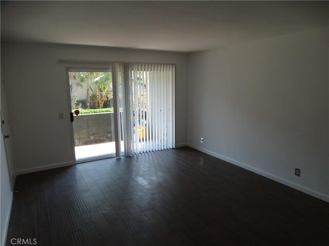 spare room featuring dark hardwood / wood-style floors