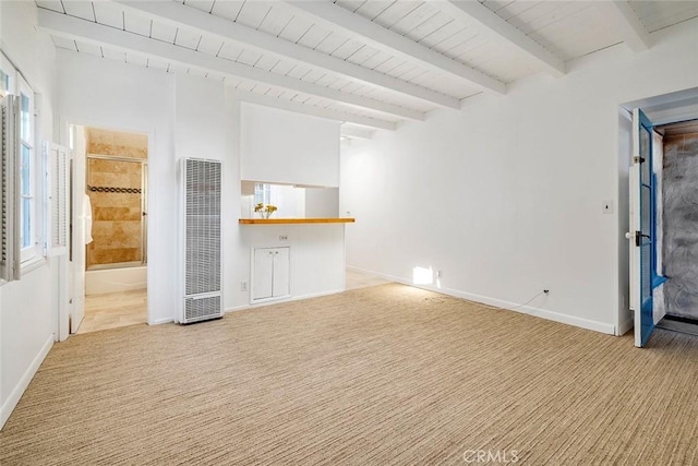 unfurnished living room featuring light carpet, beam ceiling, and wood ceiling