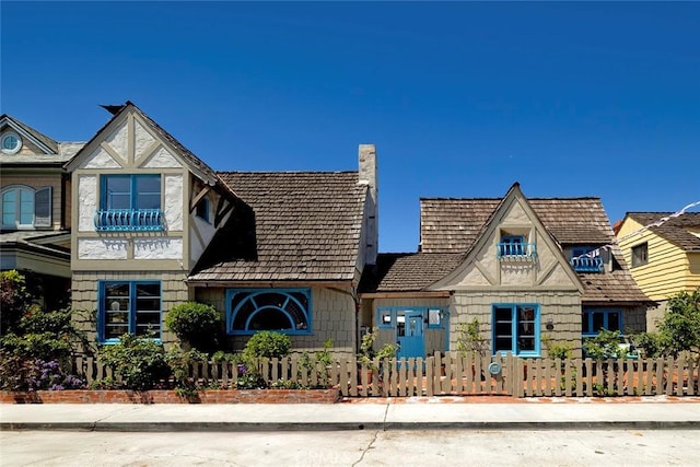 115 Apolena Ave, Newport Beach, CA 92662 - tudor house featuring a fenced front yard and a chimney
