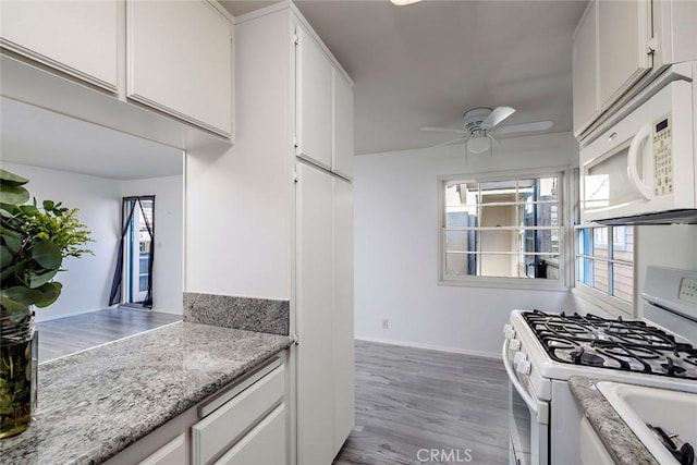 kitchen featuring light wood-type flooring, white appliances, white cabinetry, and ceiling fan