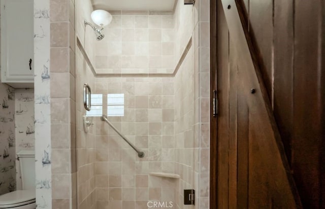 bathroom with toilet and walk in shower