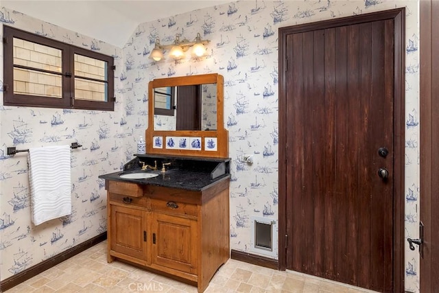 115 Apolena Ave, Newport Beach, CA 92662 - bathroom featuring vaulted ceiling, wallpapered walls, baseboards, and vanity