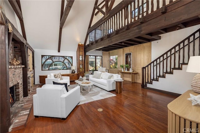 115 Apolena Ave, Newport Beach, CA 92662 - living room with high vaulted ceiling, wood finished floors, stairway, a lit fireplace, and beam ceiling
