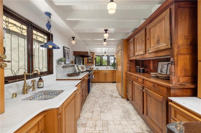 115 Apolena Ave, Newport Beach, CA 92662 - kitchen featuring stainless steel gas range, a sink, stone tile floors, brown cabinets, and beam ceiling