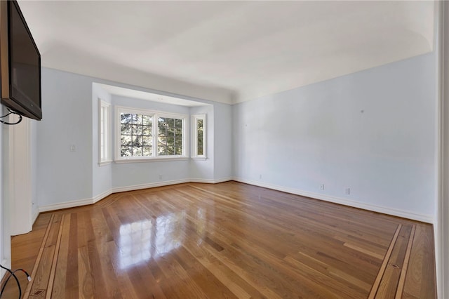 spare room with hardwood / wood-style flooring