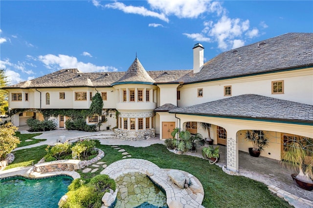 back of property featuring a lawn and a patio area