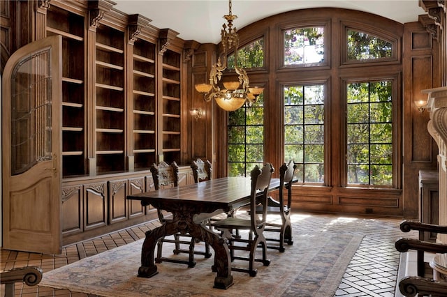 dining space with lofted ceiling, a chandelier, and plenty of natural light