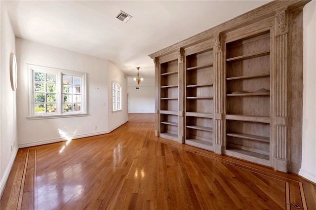 empty room with hardwood / wood-style floors