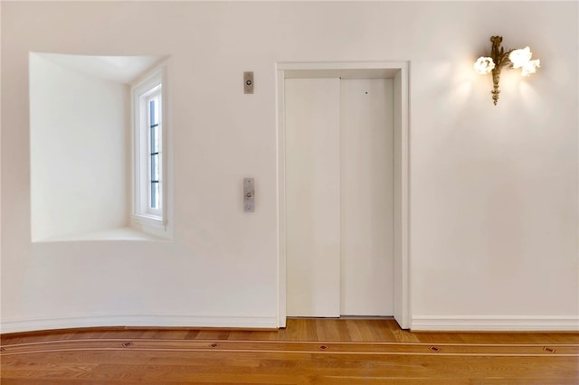 interior space featuring wood-type flooring and elevator