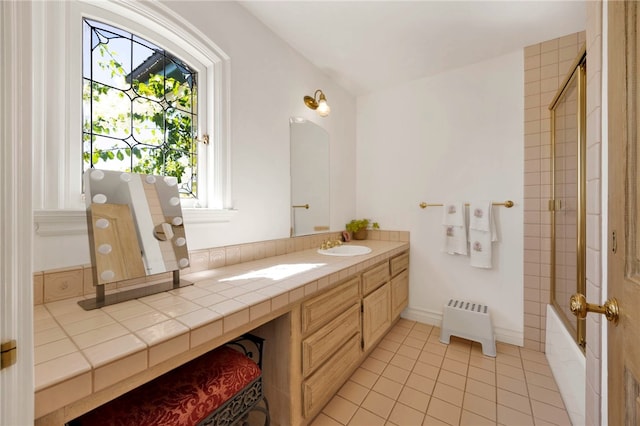 bathroom with radiator heating unit, tile patterned flooring, and vanity