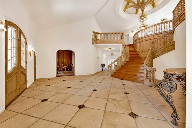 tiled foyer entrance with high vaulted ceiling