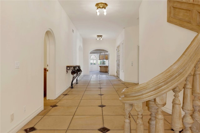 corridor with light tile patterned flooring