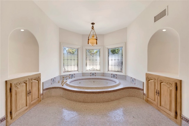 bathroom featuring tiled tub