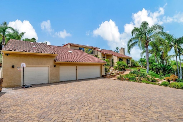 mediterranean / spanish-style home with a garage