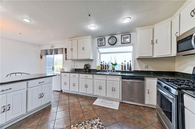 kitchen with plenty of natural light, sink, white cabinets, and stainless steel appliances