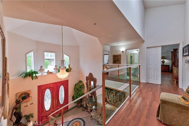 foyer entrance with hardwood / wood-style floors and a notable chandelier