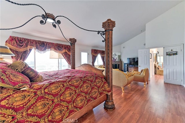 bedroom featuring vaulted ceiling and wood-type flooring