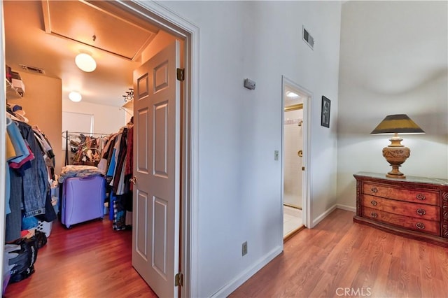 hallway with hardwood / wood-style floors