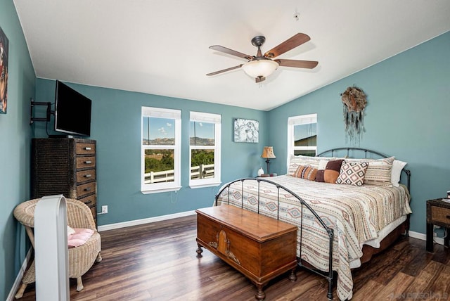 bedroom with ceiling fan, vaulted ceiling, and dark wood-type flooring