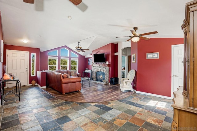 living room featuring ceiling fan, a fireplace, vaulted ceiling, and dark hardwood / wood-style flooring