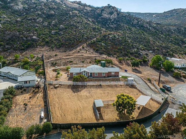 birds eye view of property featuring a mountain view and a rural view