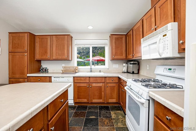 kitchen featuring white appliances and sink