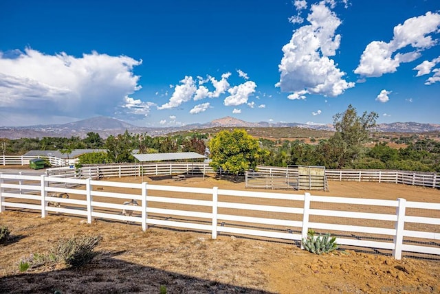 view of yard with a rural view and a mountain view