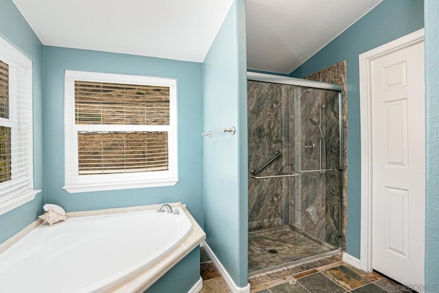 bathroom with lofted ceiling and separate shower and tub