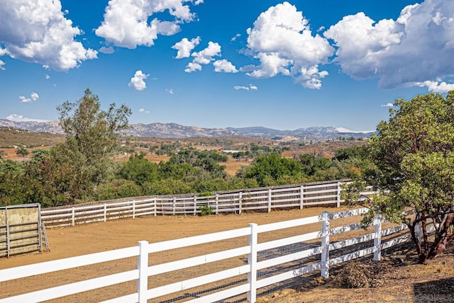 view of yard with a mountain view and a rural view