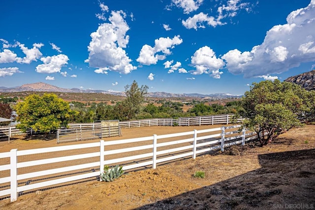 view of yard with a mountain view and a rural view