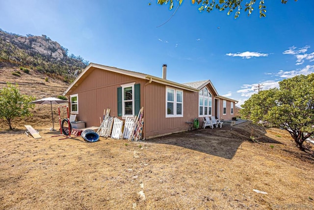 view of home's exterior featuring a patio and a mountain view