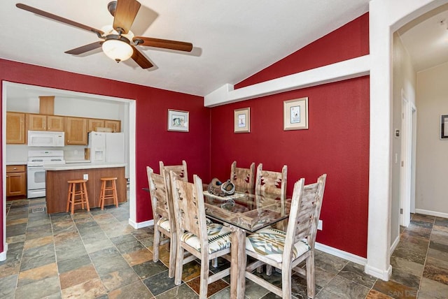 dining area featuring ceiling fan and vaulted ceiling