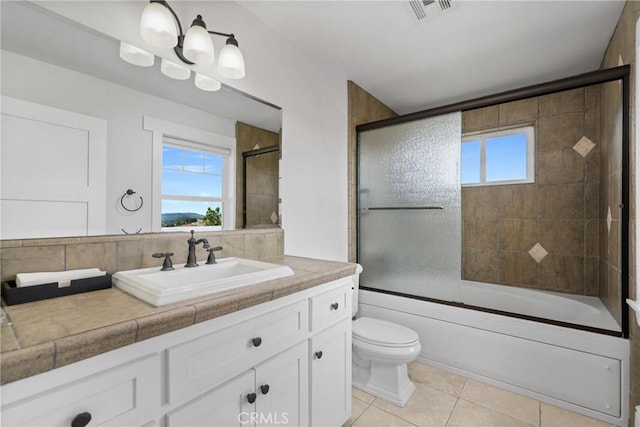 full bathroom with vanity, visible vents, tile patterned flooring, toilet, and combined bath / shower with glass door