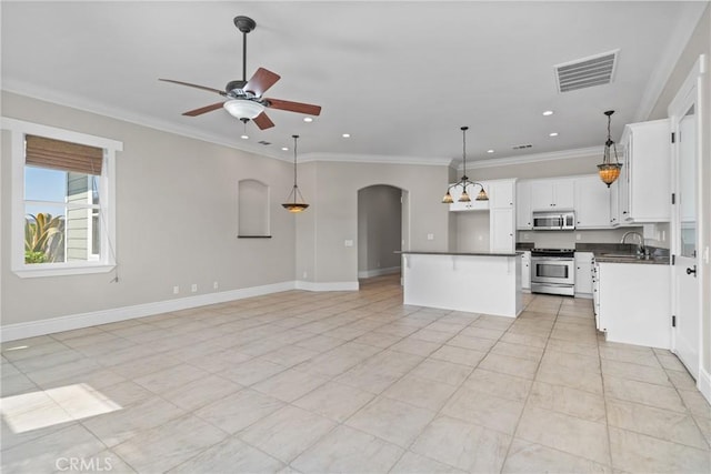 unfurnished living room featuring visible vents, crown molding, ceiling fan, arched walkways, and a sink