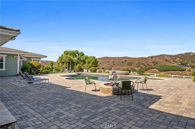 view of patio featuring a mountain view and an outdoor fire pit