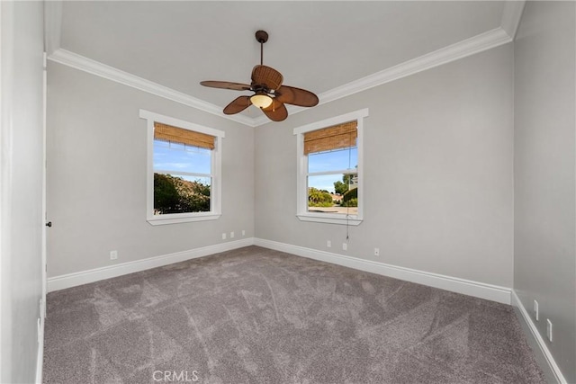 carpeted spare room featuring baseboards, a ceiling fan, and crown molding