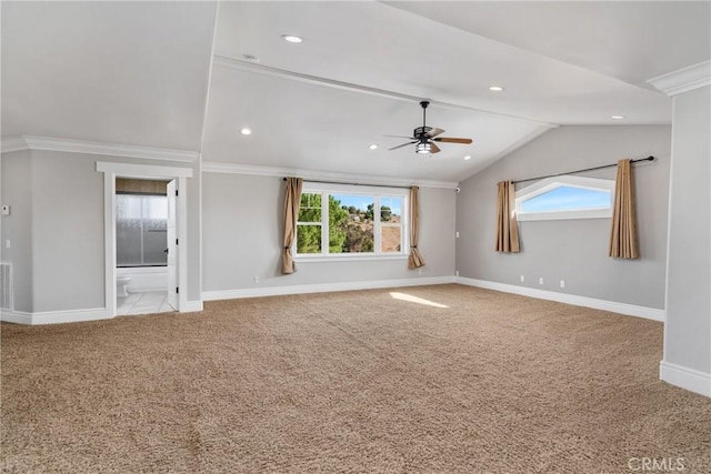 spare room with a ceiling fan, baseboards, lofted ceiling, plenty of natural light, and carpet flooring