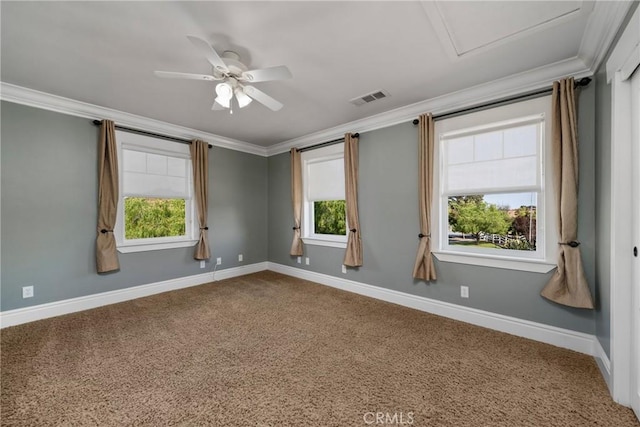 unfurnished room featuring a wealth of natural light, visible vents, and crown molding