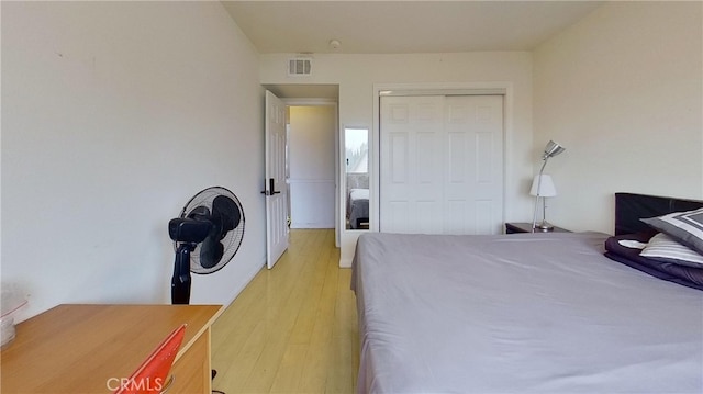 bedroom featuring a closet and light hardwood / wood-style floors