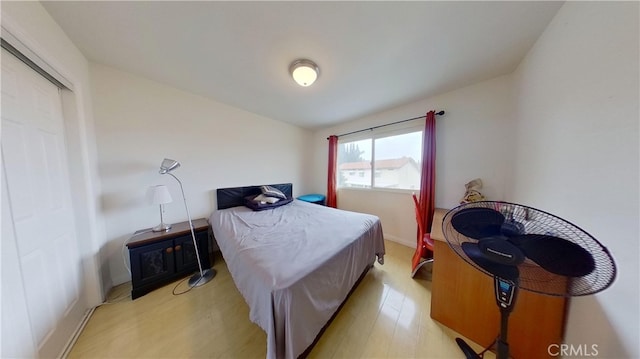 bedroom featuring vaulted ceiling and light hardwood / wood-style floors