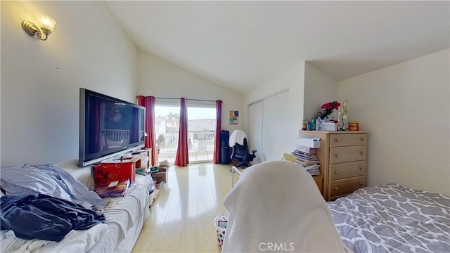 bedroom with high vaulted ceiling, a closet, and wood-type flooring